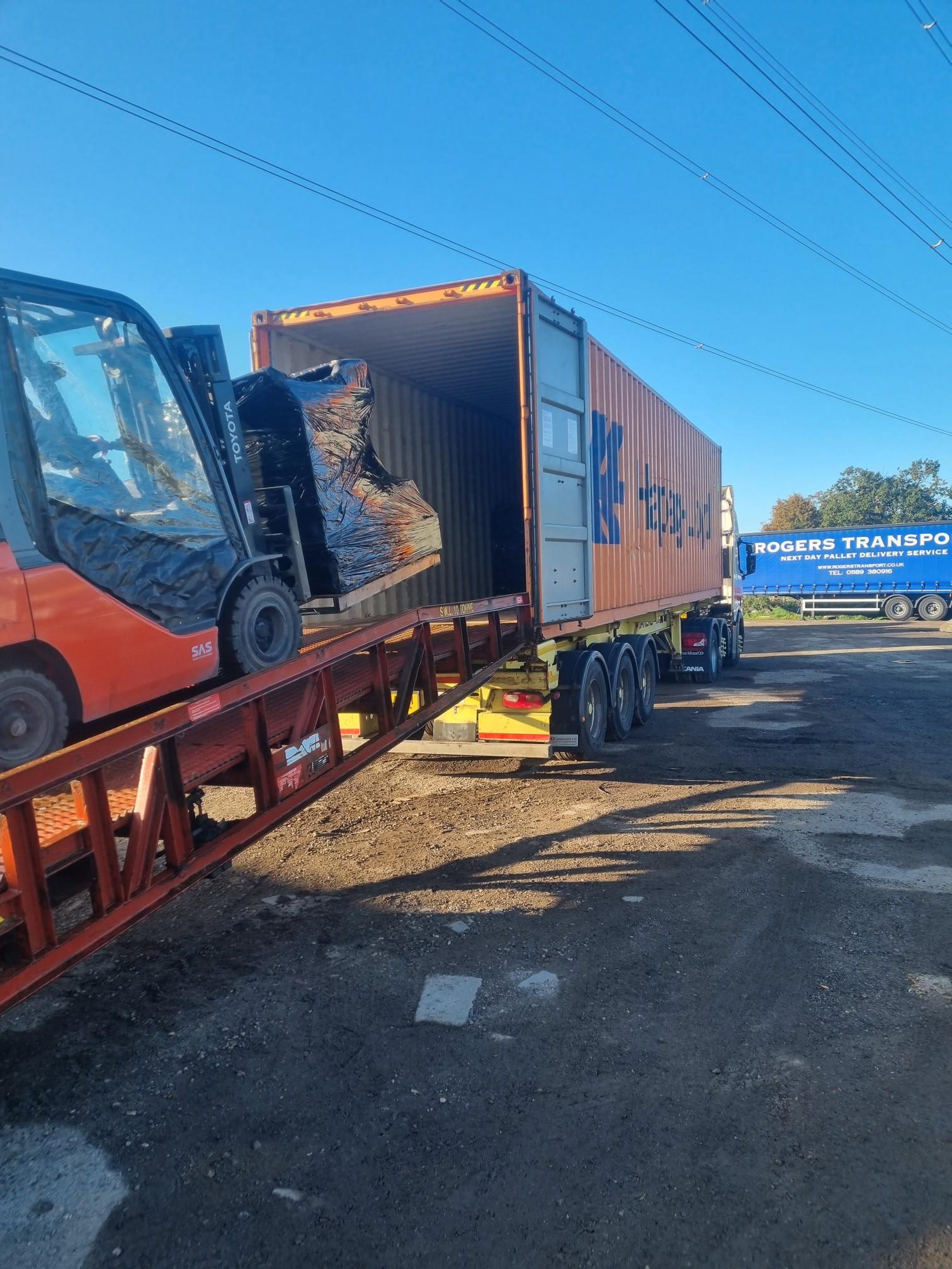 Shipping container being unloaded by Rogers Transport