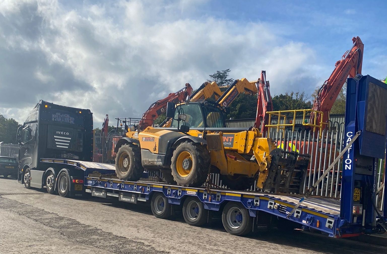 Telehandler chained down on a Rogers Transport low loader trailer