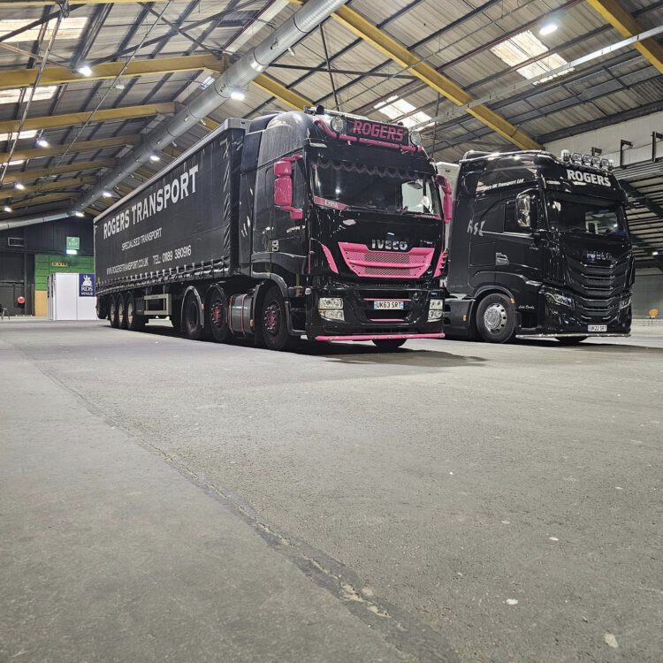 Black and pink Rogers Transport IVECO units in a warehouse